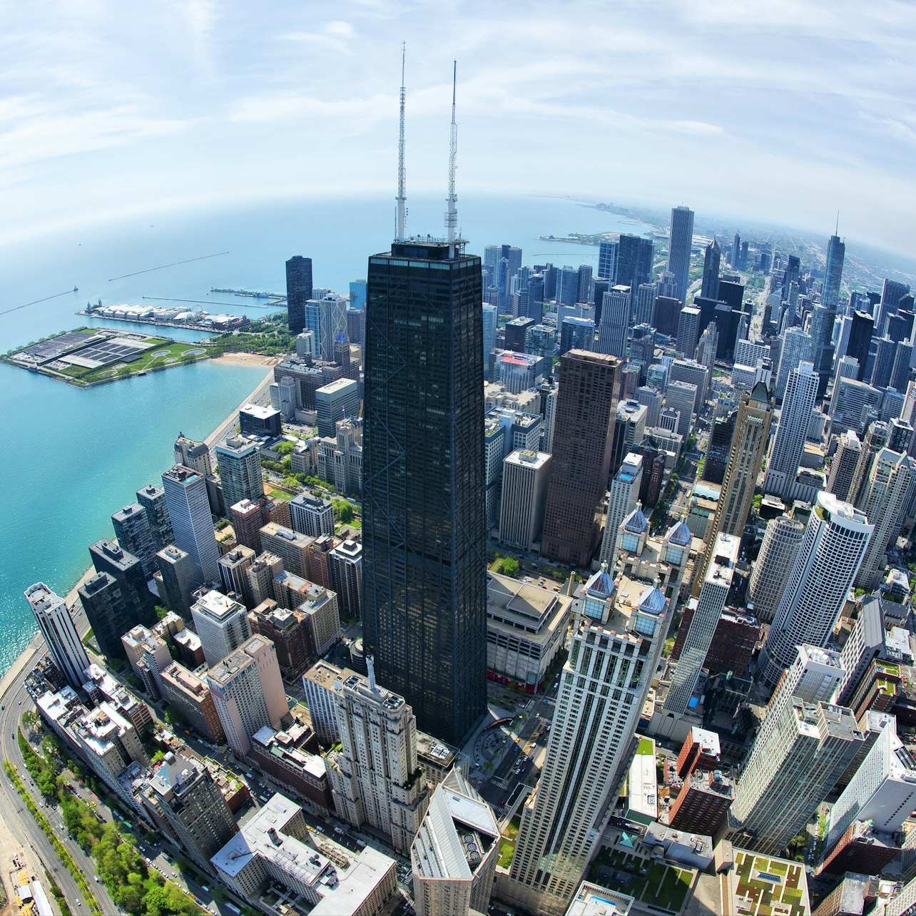 Soaring high above Chicago's skyline the 360 CHICAGO Observation Deck reveals stunning views of Lake Michigan and the city allowing for unforgettable photo opportunities and a serene escape from the bustling streets below.